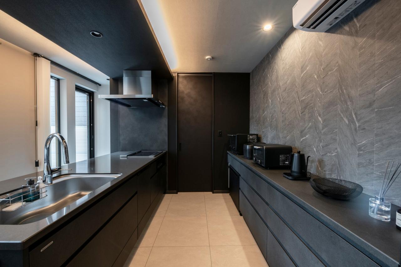 ダイニング、キッチン：間接照明が映えるブラック×グレーで統一されたキッチン