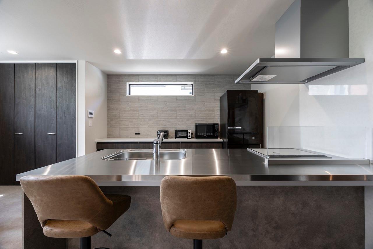 キッチン：キッチンカウンターにハイチェアをセットしバーカウンターの様な空間に